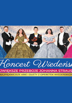 Na zdjęciu 7 postaci stojących na scenie dużego teatru. W tle widoczne miejsca dla publiczności.