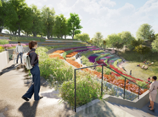 The image shows a terraced garden with colourful flower beds and people walking, sitting, and enjoying the scenery. The area is surrounded by trees and greenery, creating a peaceful, natural environment for relaxation and socializing.
