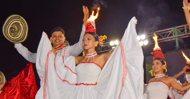Photo of a group of performers from Colombia on stage in traditional folk costumes.