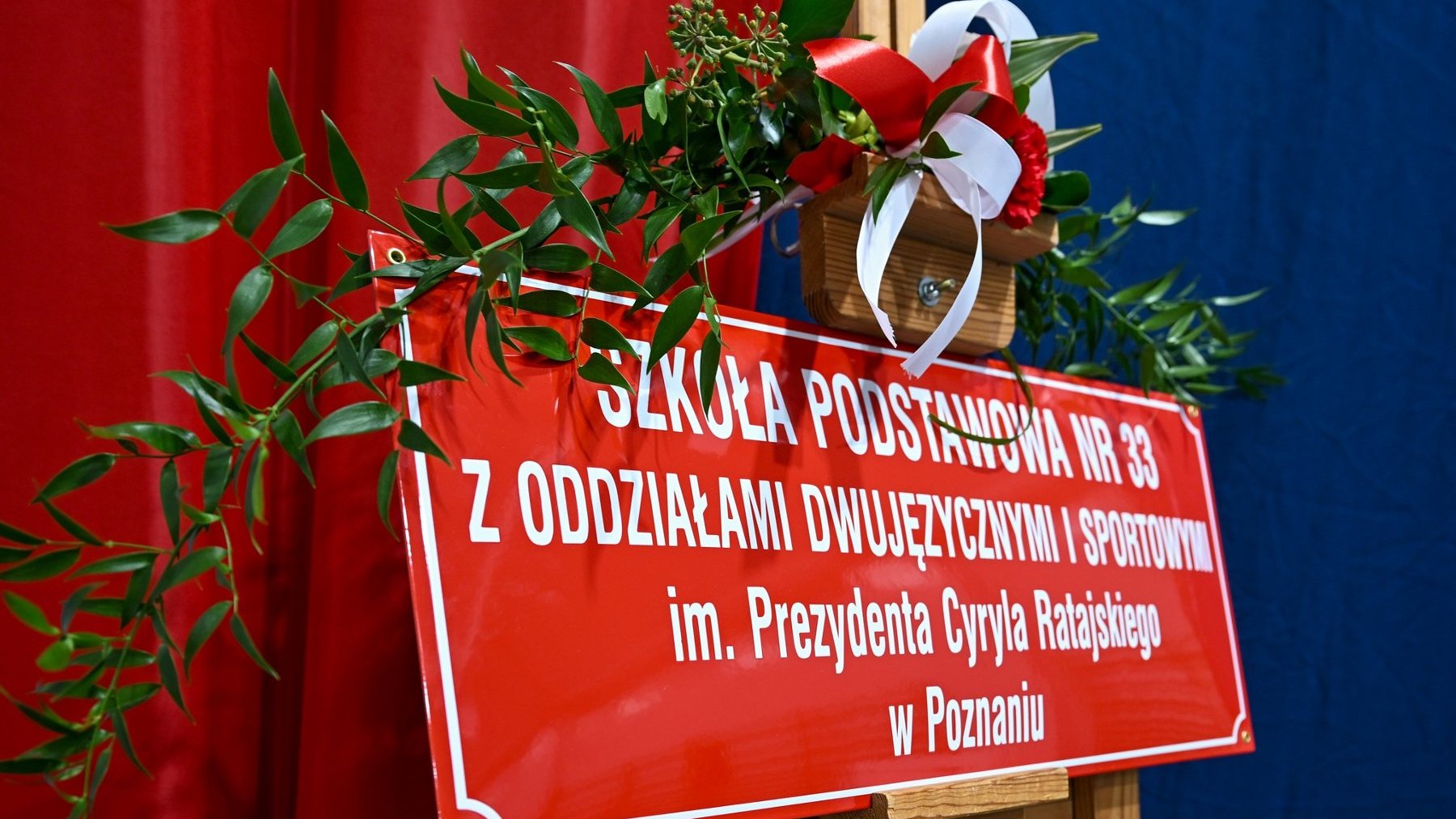 Zdjęcie przedstawia tablicę z nowym imieniem placówki.