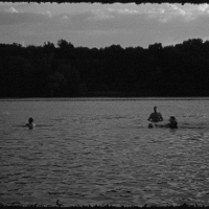 One of the exhibition works - black and white picture of a few people in a lake or river.