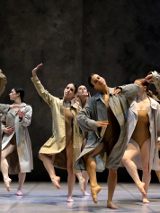 Photo from Fabula Rasa performance - dancers in coats performing on stage
