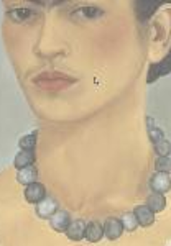 A woman with dark hair tied in a bun. The woman has a light blouse with lace trim and a necklace of dark beads. The background is dark gray.