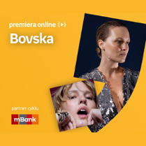 Plakat ze zdjęciem piosenkarki i okładką płyty w prawej części. W części lewej u góry białe napisy na pomarańczowym tle.