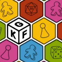 Kolorowe sześciokąty, stykają się ze sobą tworząc obraz, pośrodku jeden biały z literami K, G i F.