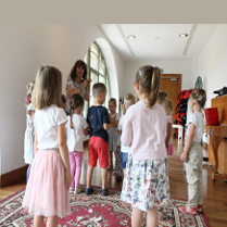 Grupa dzieci i animatorka w bawialni