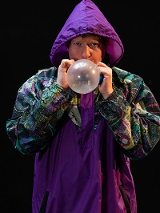 Photo of a man blowing a baloon.