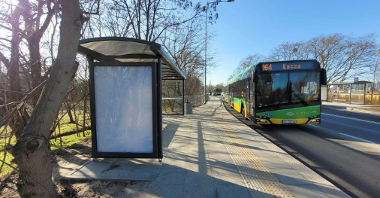 zielony autobus miejski podjeżdzający na przystanek