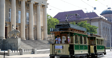 Zdjęcie przedstawia tramwaj przejeżdżający koło Opery.