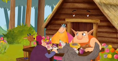 Grafika przedstawia rysunek ludzi i zwierząt siedzących za stołem z jedzeniem. W tle widać domek (co ciekawe, ma on oczy) oraz las.