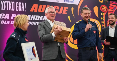 Prezydent Jacek Jaśkowiak trzymający kamienną kostkę