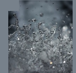 Monochromatyczna fotografia przedstawia w dużym zbliżeniu wzburzoną wodę.