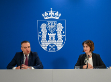 Grafika z konferencji. Przedstawia dwie osoby - dyrektor WDGIR Joanna Jajus i wiceprezydenta miasta Poznania Mariusz Wiśniewski.