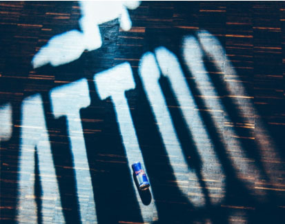 Duzy napis: Tattoo i mała puszka Red Bulla na drugiej literze "t"