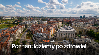 Zdjęcie z lotu ptaka, fragment miasta z kamienicami, ulicami i parkami.