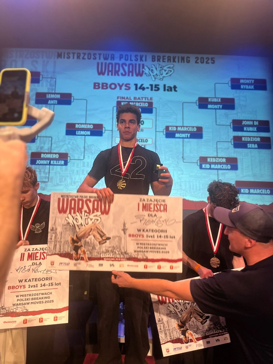 Zawodnik Stowarzyszenia Breaking na podium Mistrzostw Polski - zawodnik stoi z dyplomem i medalem na szyi