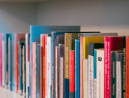 Zdjęcie przedstawia książki na półce.