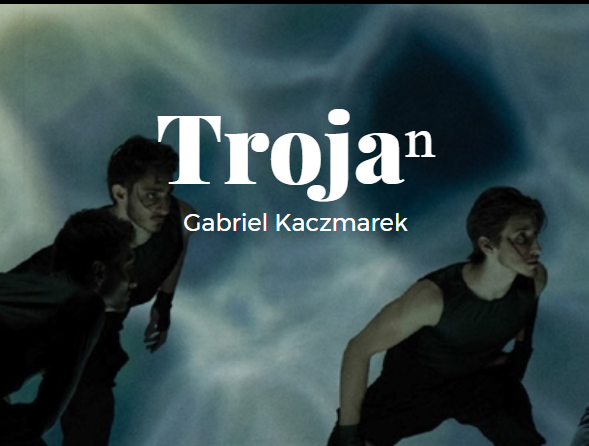 zdjęcie przedstawia dwie postaci w ruchu, pochylone, ubrane na czarno, pośrodku biały napis Trojan, poniżej Gabriel Kaczmarek