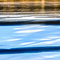 Odbicie zachodzącego słońca na tafli wody jeziora.