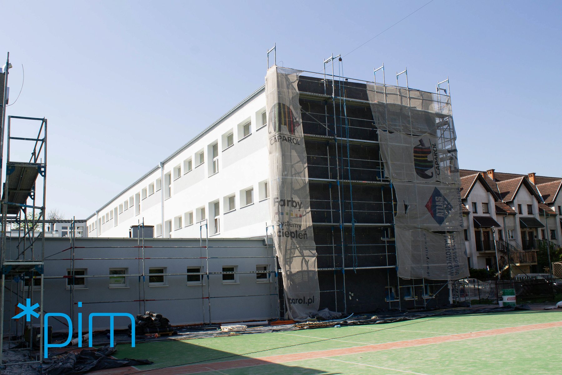 Galeria zdjęć przedstawia budynek szkoły, w którym prowadzone są prace termomodernizacyjne. Widać na nim m.in. rusztowania. - grafika artykułu