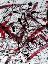 Abstrakcyjne czarno-czerwono-białe bohomazy na białym tle.