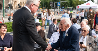 Na zdjęciu Jacek Jaśkowiak, prezydent Poznania, witający się ze starszym mężczyzną, Zenonem Wechmannem