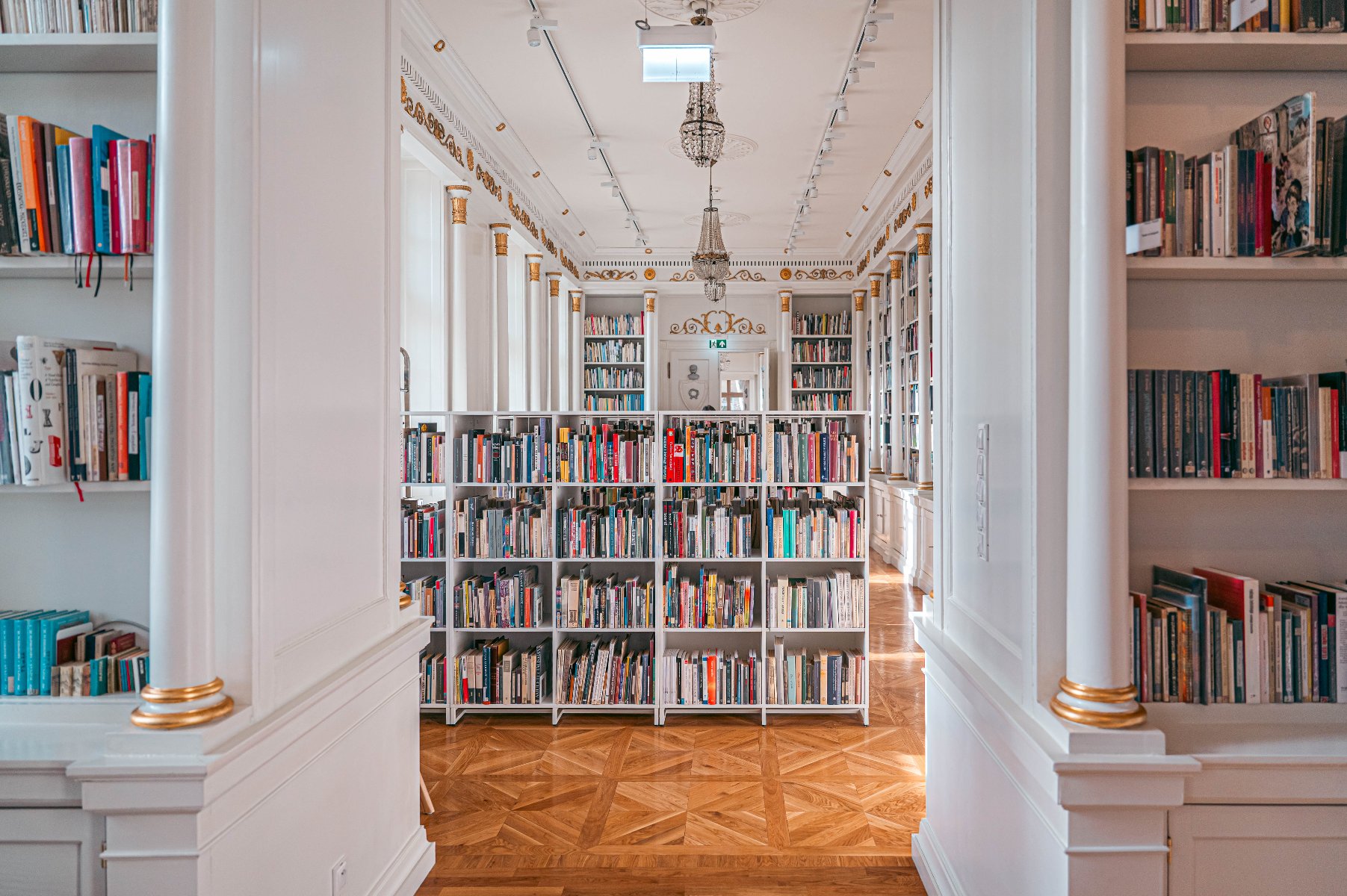 Organizatorem wystawy z okazji 1000-lecia koronacji Bolesława Chrobrego jest poznańska Biblioteka Raczyńskich Zdjęcie przedstawia wnętrze biblioteki. Widać na nim półki z książkami.