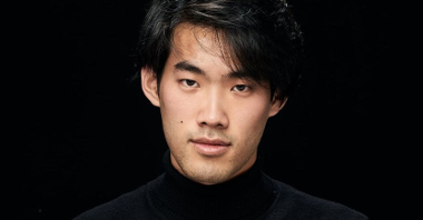 Photograph of Bruce Liu - face of the artist on the black background