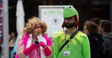 A woman and a man in disguise - one of them as Kermit the frog and another as Miss Piggy