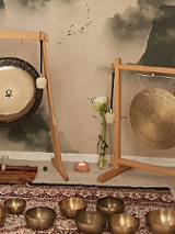 Sala, w której roztawione są misy i gongi na wzorzystym dywanie.