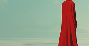 Grafika przedstawia postać w czerwonym płaszczu, która stoi tyłem. Postać jest zamknięta w szklanej książce, przez którą przechodzi do innego świata.