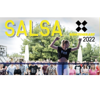 "Salsa w KontenerART 2022". Tańcząca kobieta na scenie, a za nią tłum ludzi.