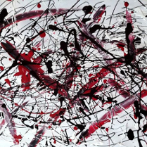 Abstrakcyjne czarno-czerwono-białe bohomazy na białym tle.