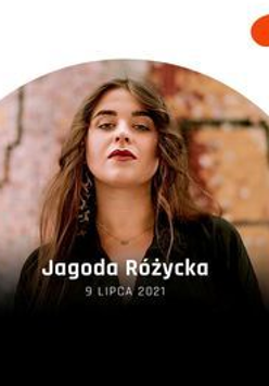 Kobieta z długimi brązowymi włosami patrzy w obiektyw.